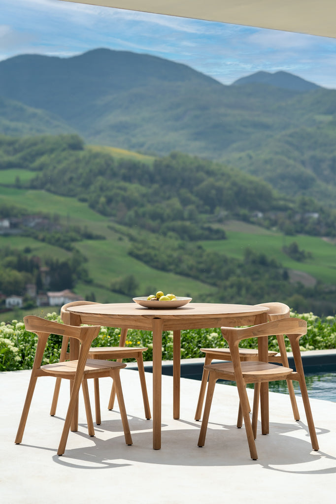 Bok Outdoor Dining Table Round with Bok Outdoor Dining Chairs next to a modern pool overlooking a beautiful scenic landscape. - Saffron and Poe, Ethnicraft