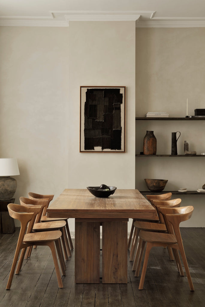 Teak Bok Dining Chairs in neutral dining room with open shelving, modern art and vintage wood floors. - Saffron and Poe, Ethnicraft