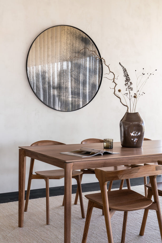 Teak Bok Dining Table and Chairs in bright dining room with round mirror and kilim rug. - Saffron and Poe, Ethnicraft