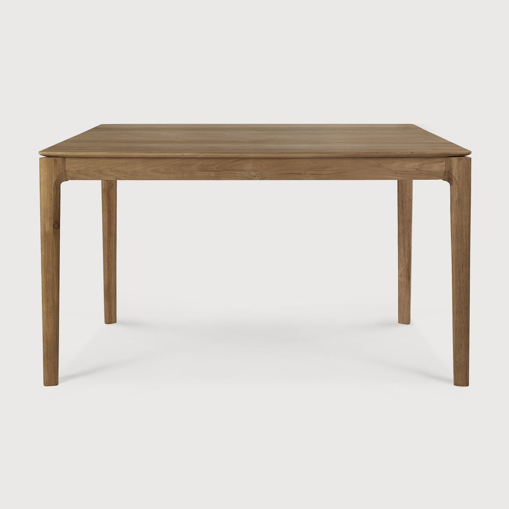 Small Teak Bok Dining Table side view with white background, featuring floating table top and beautiful wood joinery. - Saffron and Poe, Ethnicraft
