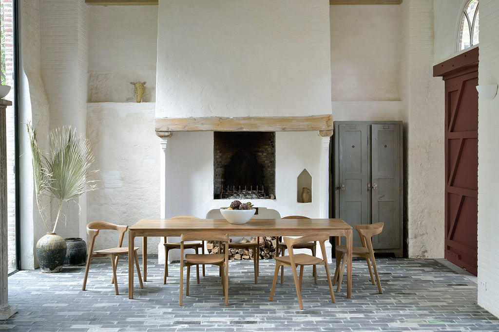 Teak Bok Dining Table and Chairs in European inspired dining room with plaster fireplace and paver floors. - Saffron and Poe, Ethnicraft
