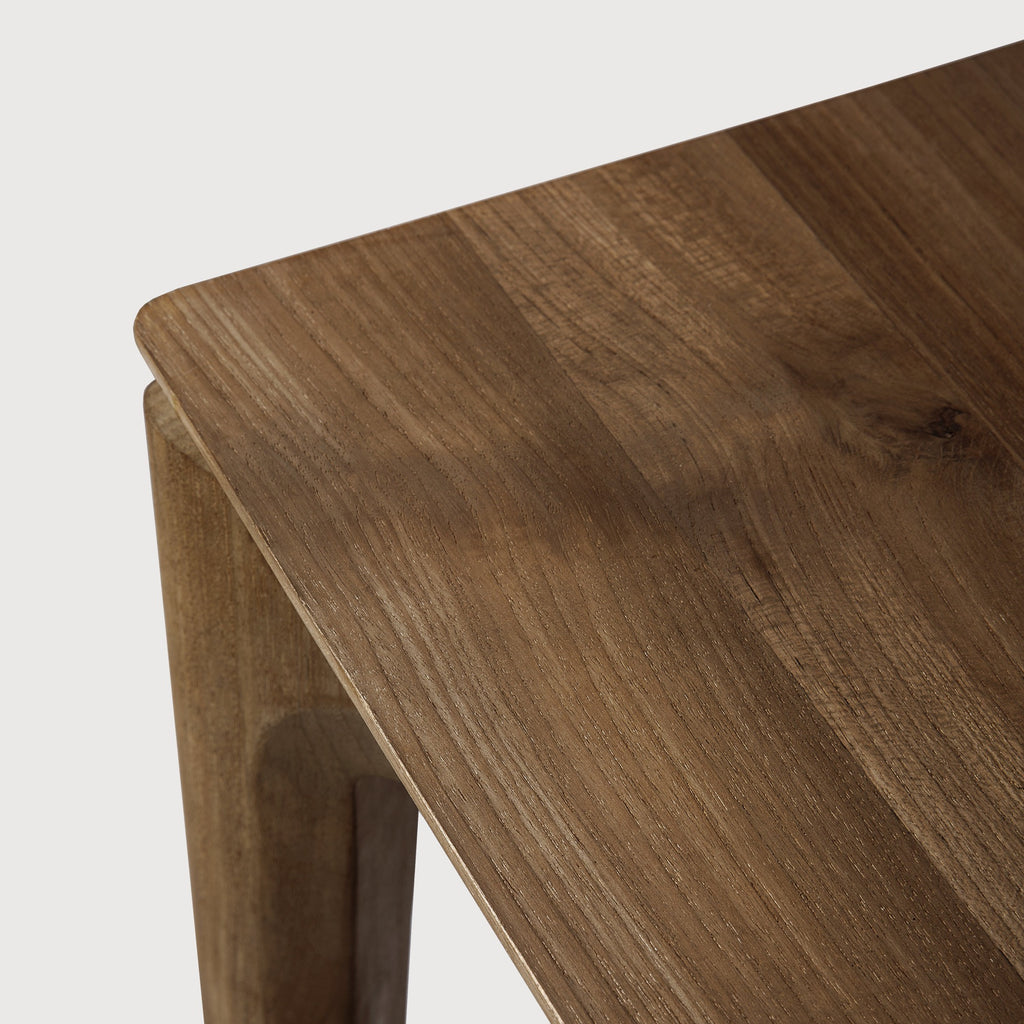 Teak Bok Dining Table close up detail with white background featuring floating table top and beautiful wood joinery. - Saffron and Poe, Ethnicraft