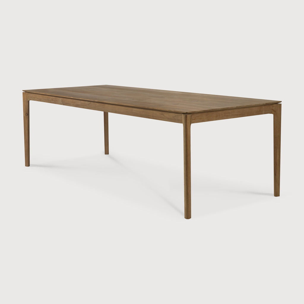 Teak Bok Dining Table with white background at an angle, with floating table top and beautiful wood joinery. - Saffron and Poe, Ethnicraft