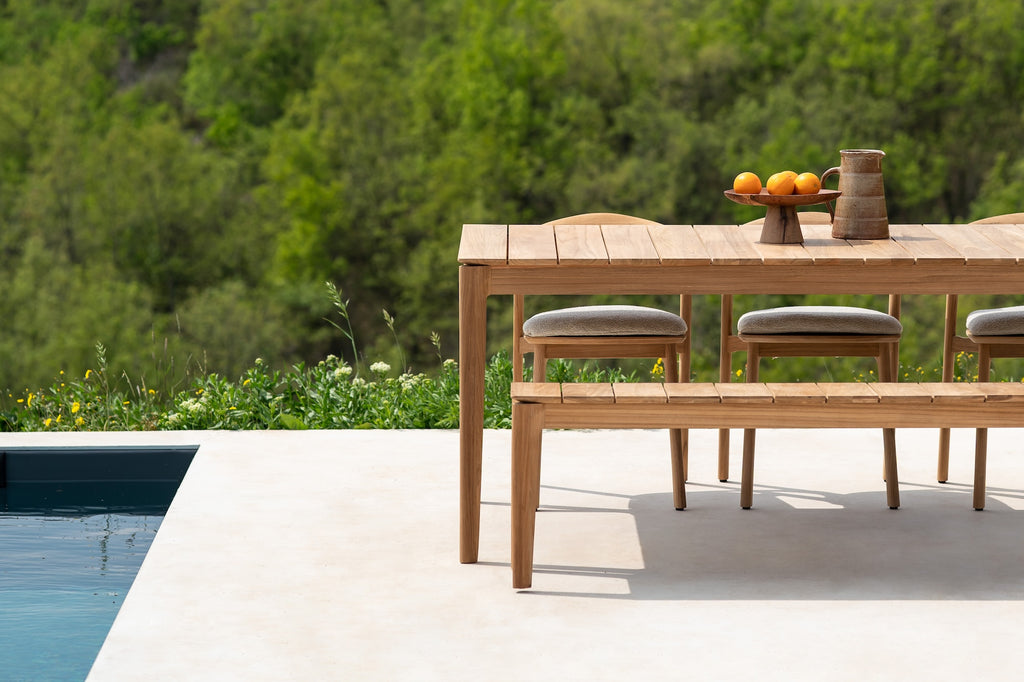 Bok Outdoor Dining Table with Slatted Teak Bok Outdoor Bench next to a modern poolside, styled with a ceramic bowl and vessel. - Saffron and Poe, Ethnicraft