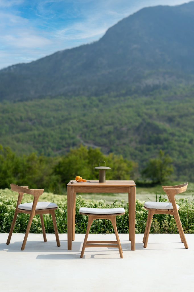 Bok Outdoor Dining Table with Bok Outdoor Dining Chairs overlooking a beautiful scenic landscape. - Saffron and Poe, Ethnicraft