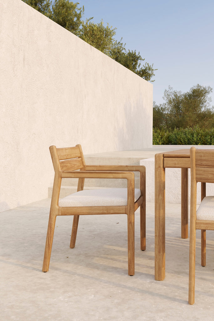 Jack Outdoor Dining Chairs and off white cushion seat with Jack Outdoor Dining Table on an outdoor patio. - Saffron and Poe, Ethnicraft