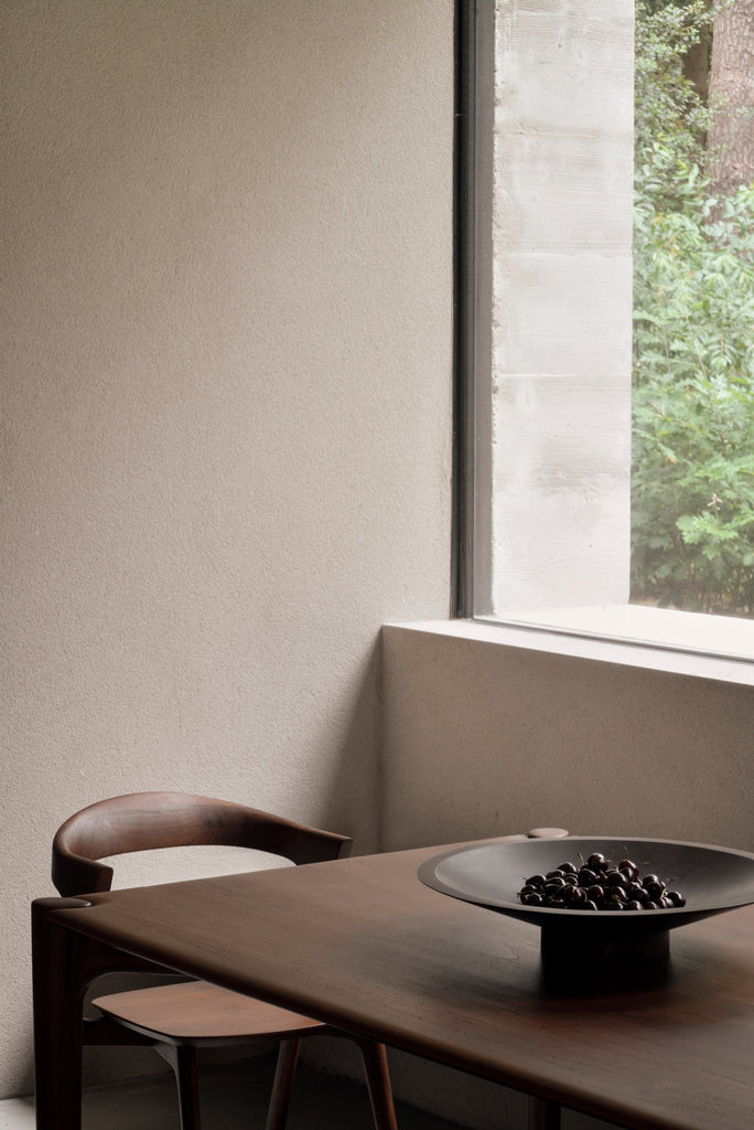 Dark Teak Bok Chairs in bright modern European dining room with a bowl of cherries. - Saffron and Poe, Ethnicraft