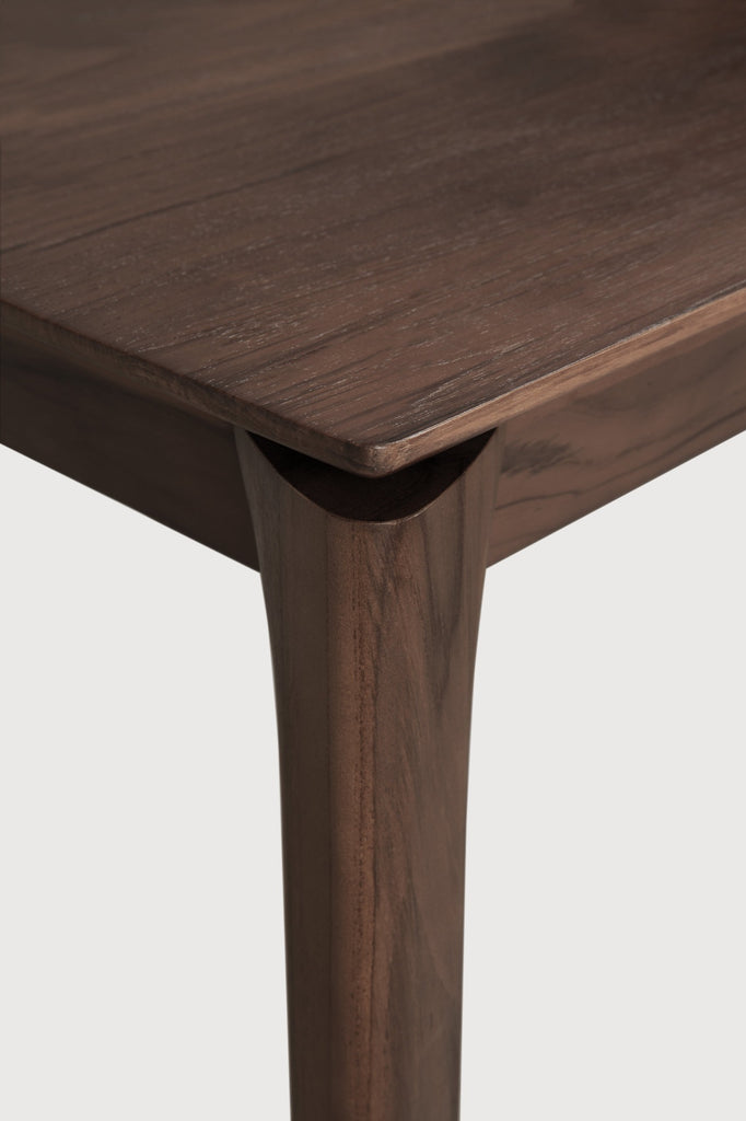 Darkened Teak Bok Dining Table close up detail of float top with white background featuring floating table top and beautiful wood joinery. - Saffron and Poe, Ethnicraft