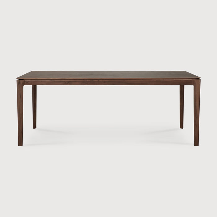 Darkened Teak Bok Dining Table side view with white background, featuring floating table top and beautiful wood joinery. - Saffron and Poe, Ethnicraft
