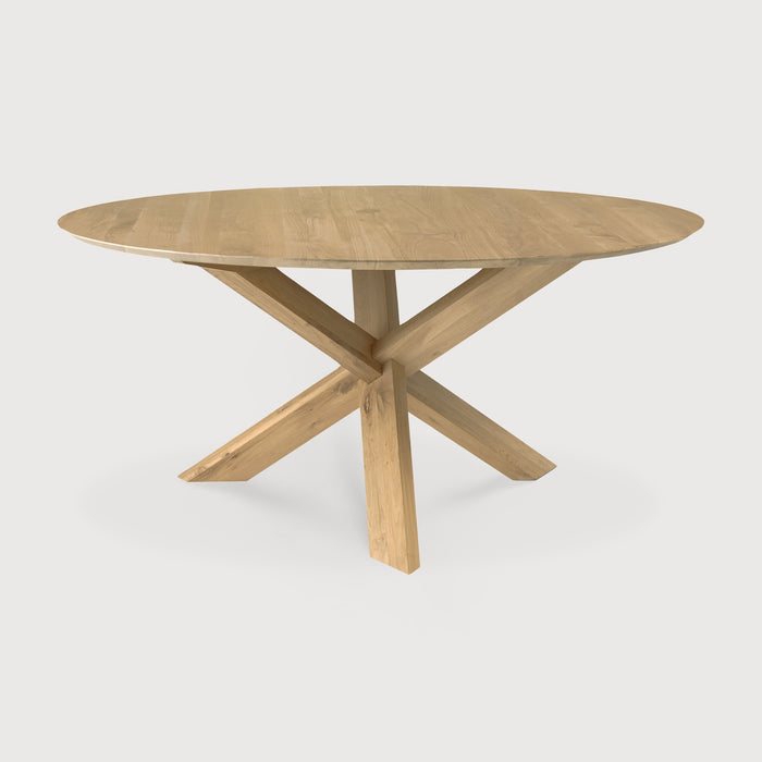  White Oak Circle Dining Table front angle with white background and beautiful intersecting wood legs. - Saffron and Poe, Ethnicraft