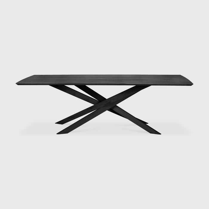 Black Oak Rectangle Mikado Dining Table front angle with white background and beautiful intersecting wood legs. - Saffron and Poe, Ethnicraft