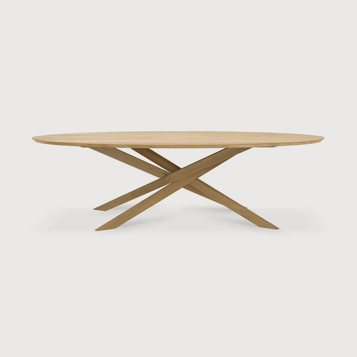 White Oak Oval Mikado Dining Table front angle with white background and beautiful intersecting wood legs. - Saffron and Poe, Ethnicraft