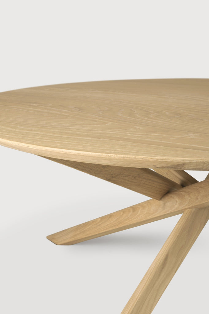 White Oak Oval Mikado Dining Table detail with white background and beautiful intersecting wood legs. - Saffron and Poe, Ethnicraft