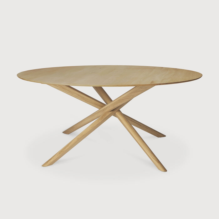 White Oak Round Mikado Dining Table with white background and beautiful intersecting wood legs. - Saffron and Poe, Ethnicraft