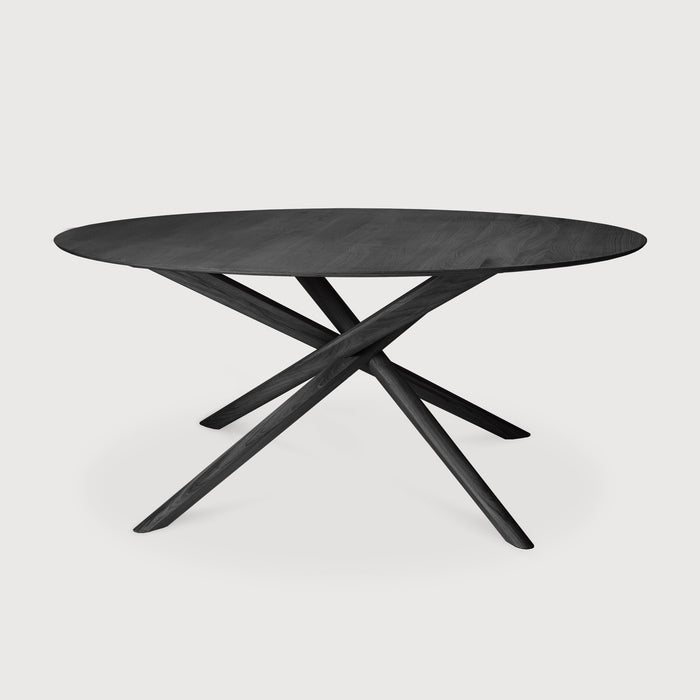 Black Oak Round Mikado Dining Table with white background and beautiful intersecting wood legs. - Saffron and Poe, Ethnicraft