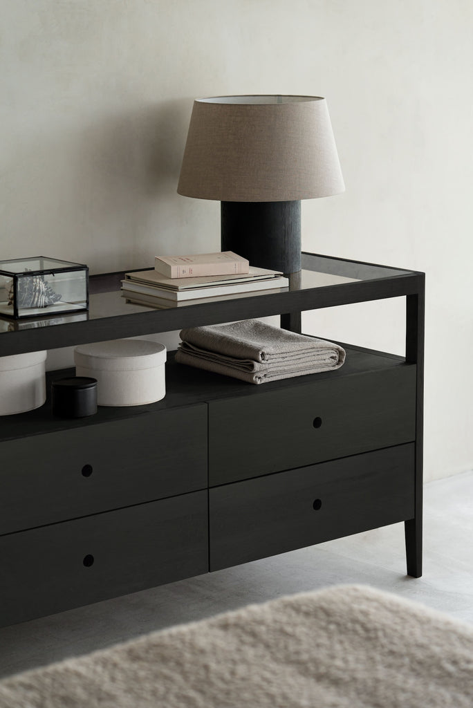 Solid black oak dresser with 4 drawers, glass top, tapered legs and rounded edges add a soft quality to this stylish storage solution - view in a room - Saffron and Poe, Ethnicraft