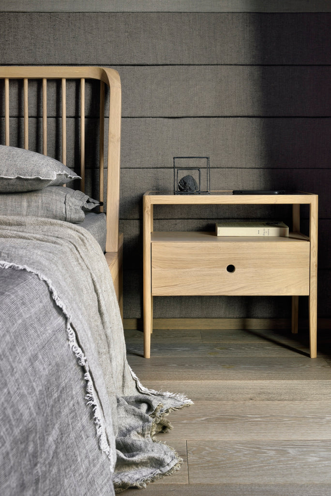 White Oak Spindle Bed detail view vignette in charcoal room with grey bedding and Spindle Bedside Table. - Saffron and Poe, Ethnicraft