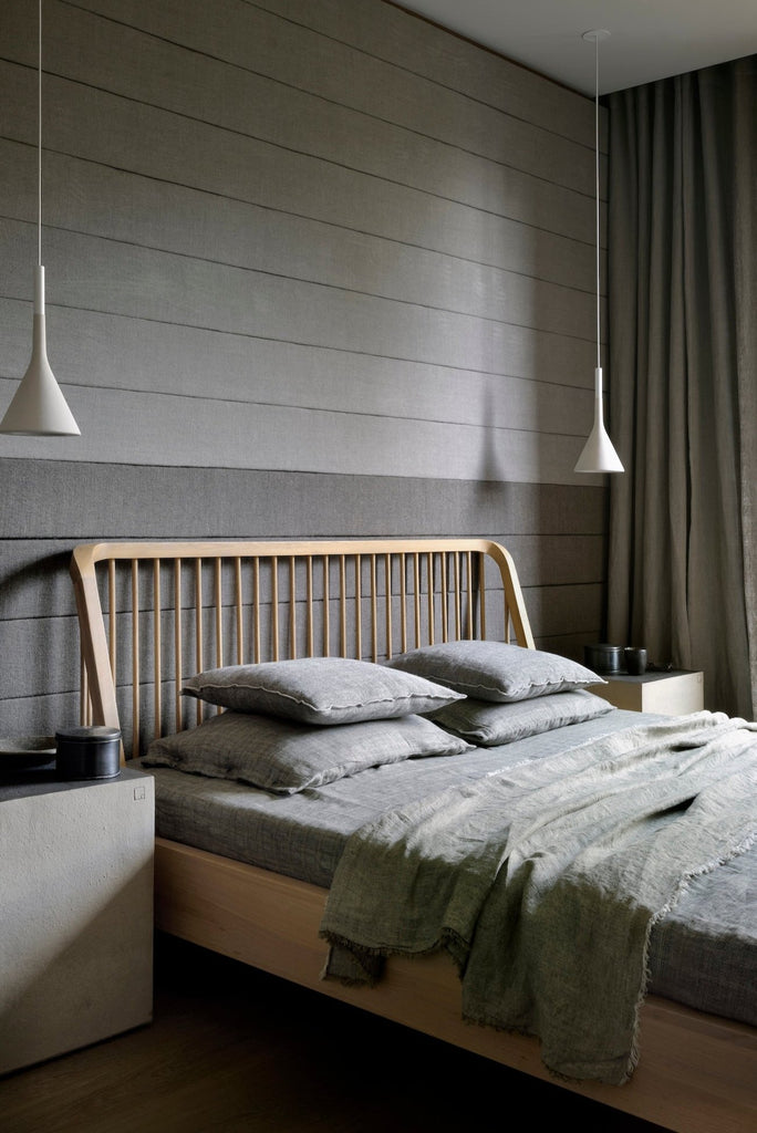 White Oak Spindle Bed angle view vignette in charcoal room with bedside pendants and grey bedding. - Saffron and Poe, Ethnicraft