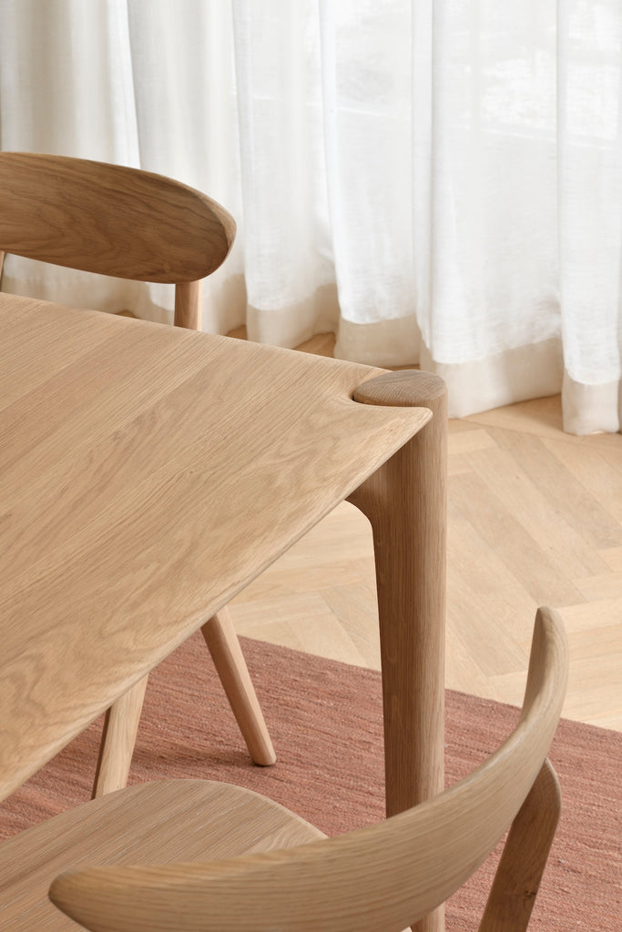 White Oak PI Dining Table close up top view in European inspired interior featuring beautiful wood joinery. - Saffron and Poe, Ethnicraft
