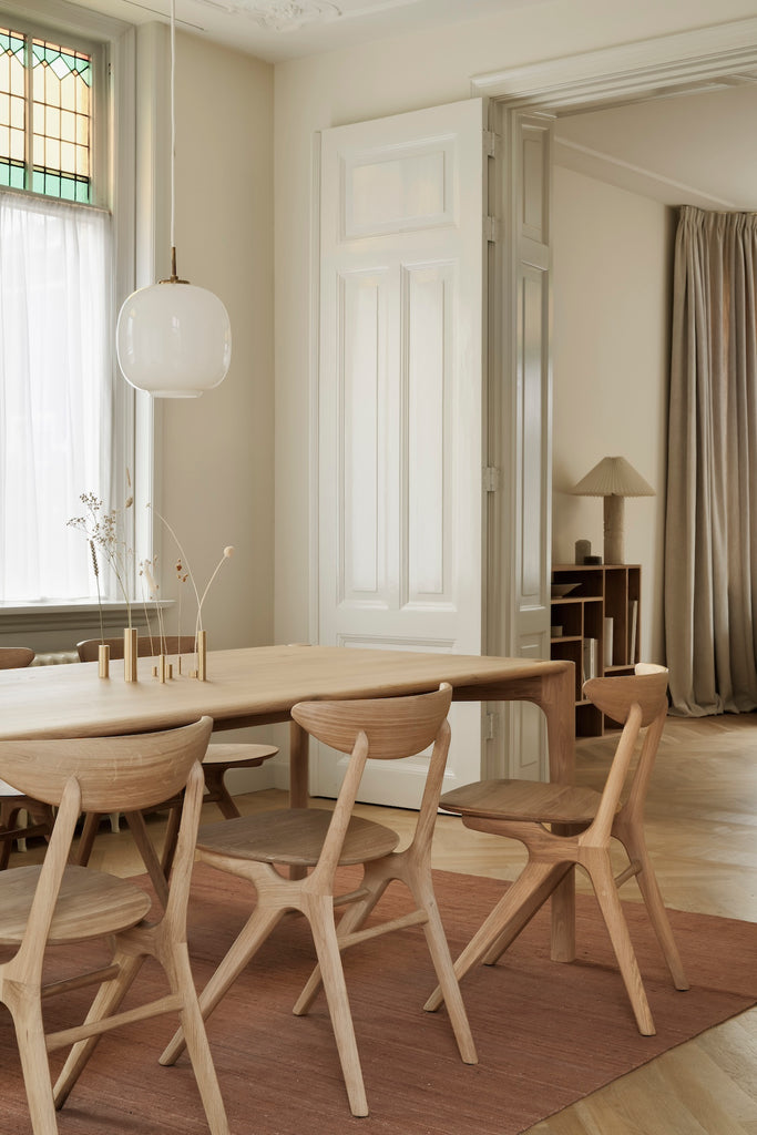 White Oak PI Dining Table detail vignette with beautiful wood joinery in European inspired interior with oak herringbone floors and rust colored area rug. - Saffron and Poe, Ethnicraft