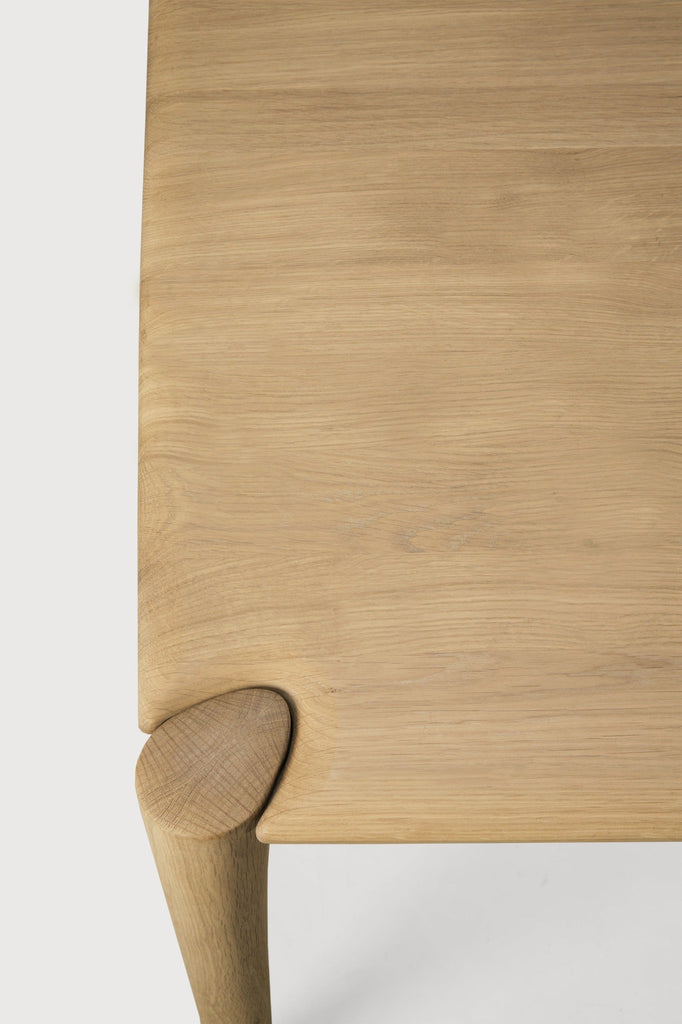 White Oak PI Dining Table close up top view with white background and featuring beautiful wood joinery. - Saffron and Poe, Ethnicraft