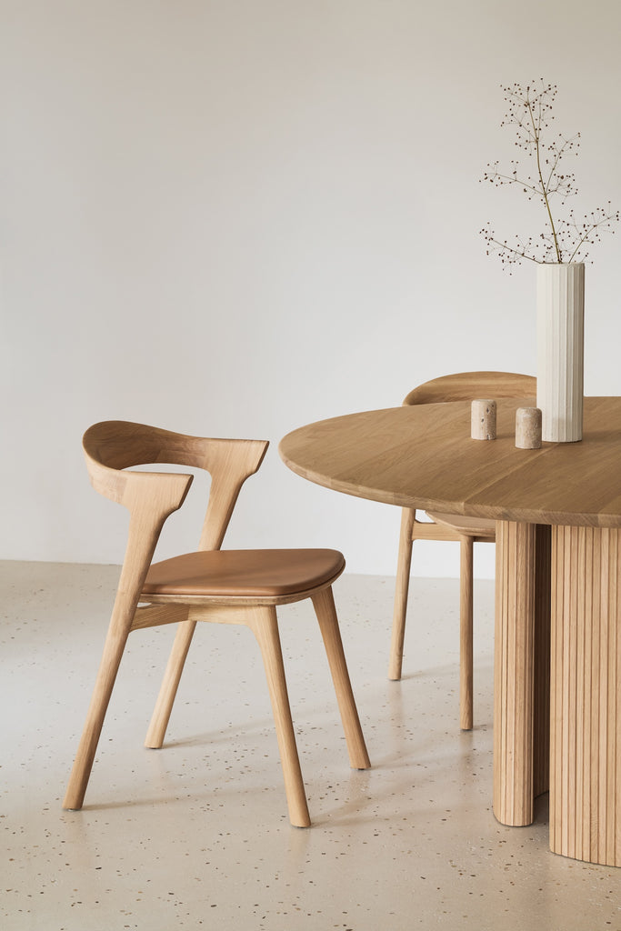 White Oak Bok Dining Chair with sienna leather seat paired with round oak dining table  - Saffron and Poe, Ethnicraft