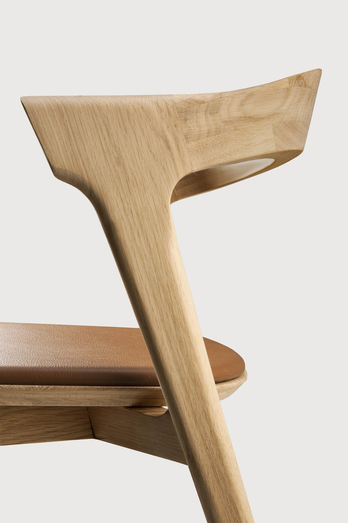 White Oak Bok Dining Chair with saddle leather seat detail with white background and beautiful wood joinery. - Saffron and Poe, Ethnicraft