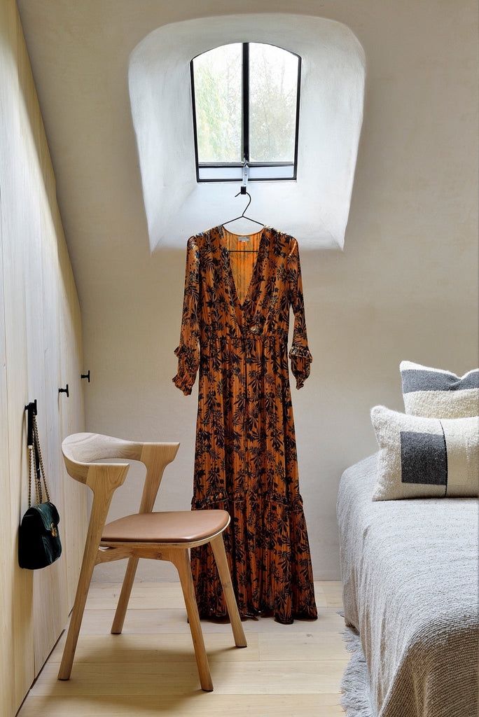 White Oak Bok Chairs with saddle leather seat in bright bedroom with orange floral dress and minimal bed. - Saffron and Poe, Ethnicraft