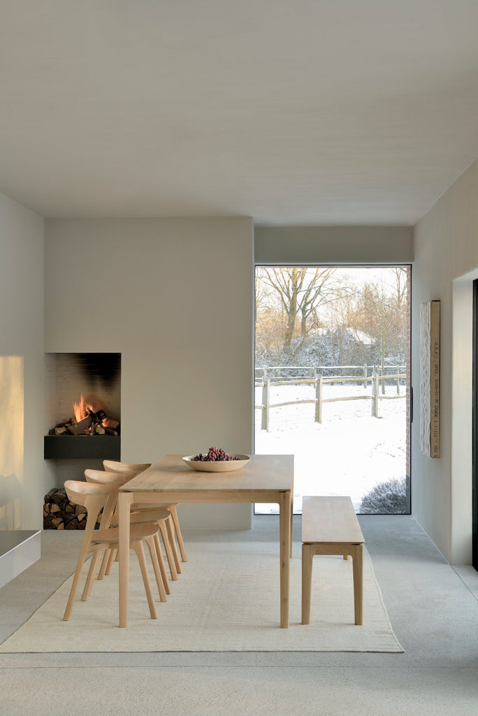 White Oak Bok Bench, Bok dining chairs and Bok dining table in Plastered Modern European inspired dining room with fireplace. - Saffron and Poe, Ethnicraft