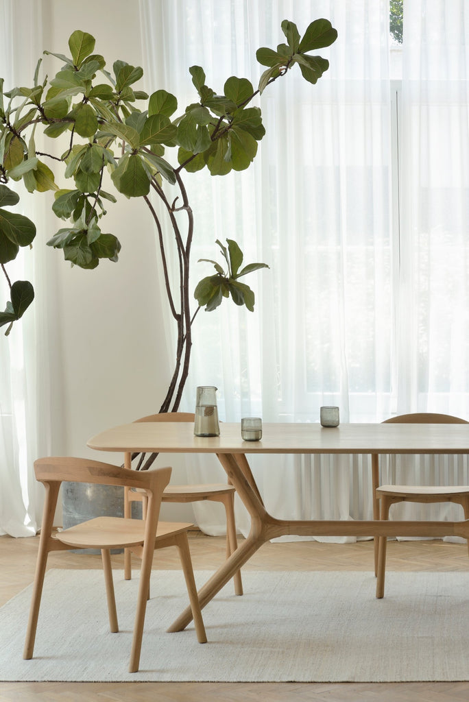 Teak Bok Dining Chairs Modern bright dining room with sheer curtains and fiddle leaf fig tree. - Saffron and Poe, Ethnicraft