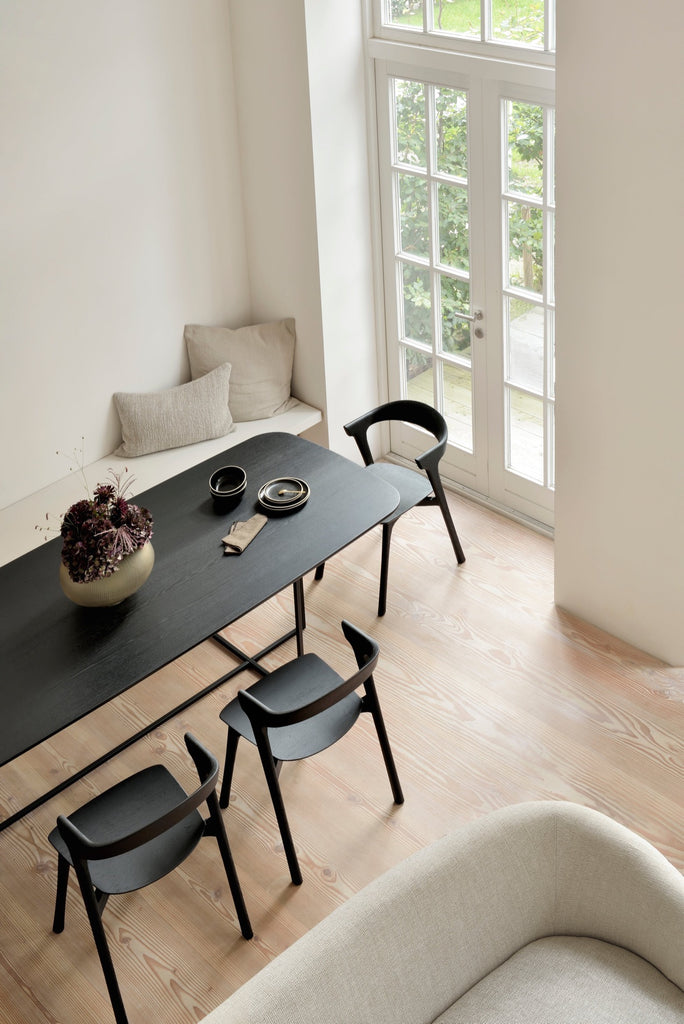 Black Oak Bok Chairs in bright modern European dining room with high ceilings and wood floors from above. - Saffron and Poe, Ethnicraft