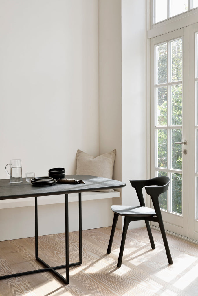 Black Oak Bok Chairs in bright modern European dining room with high ceilings and wood floors. - Saffron and Poe, Ethnicraft