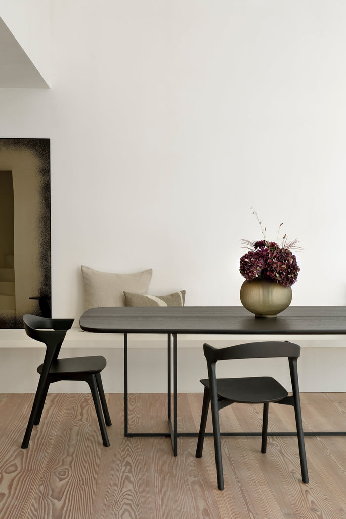Black Oak Bok Chairs in bright modern European dining room with high ceilings and wood floors. - Saffron and Poe, Ethnicraft