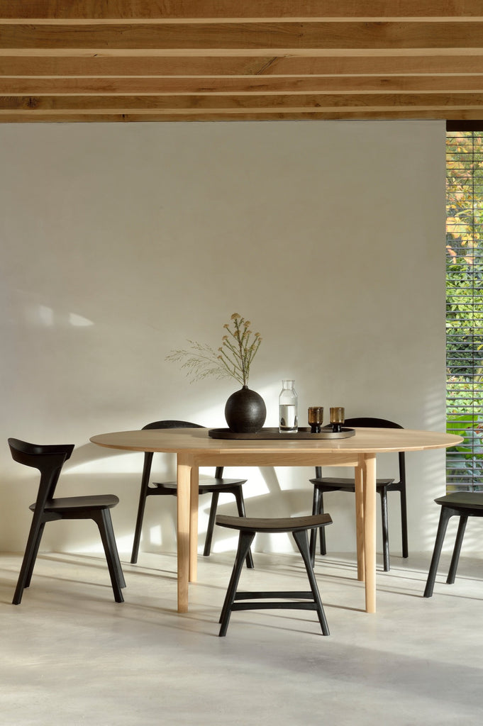 Black Oak Bok Dining Chairs and Oak Bok Dining Table in European inspired dining room with high ceilings and exposed beams, plaster fireplace and floors. - Saffron and Poe, Ethnicraft