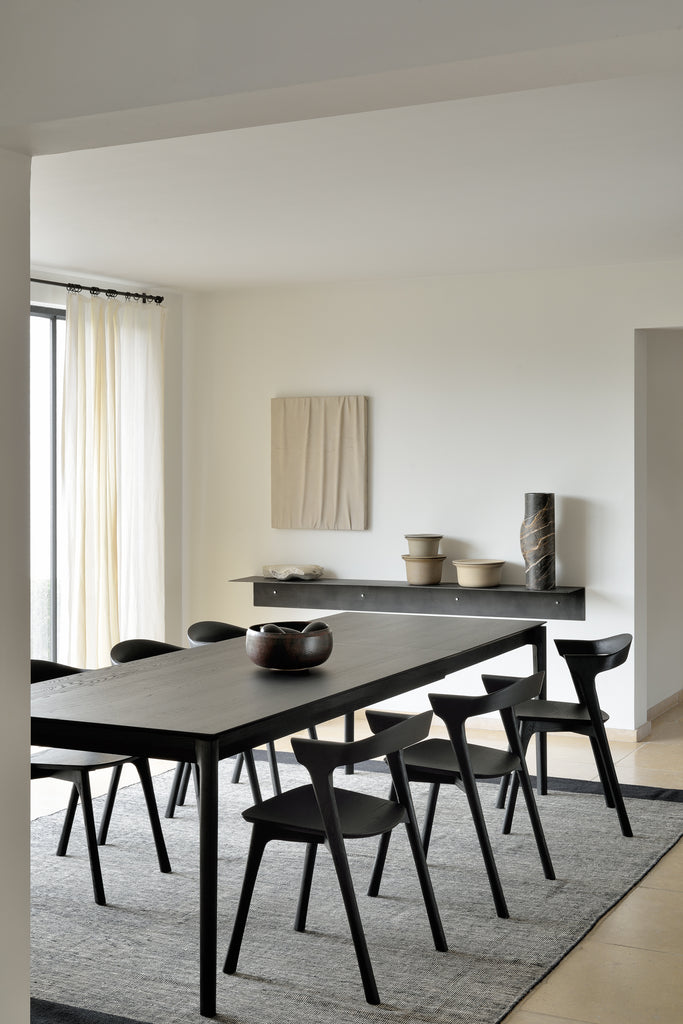 Black Oak Bok Chairs in bright modern European dining room with high ceilings and wood floors. - Saffron and Poe, Ethnicraft