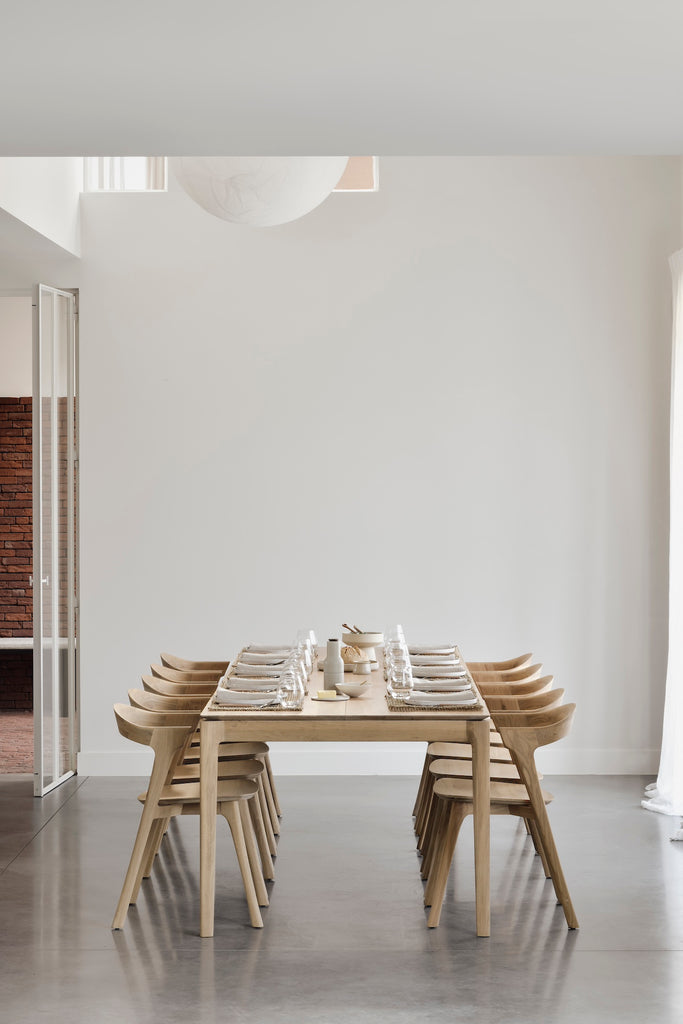 Oak Bok Extendable Dining Table in dining room with ten place table setting  featuring floating table top and beautiful wood joinery. - Saffron and Poe, Ethnicraft