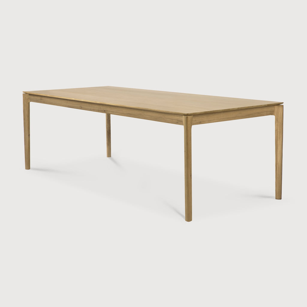 White Oak Bok Dining Table with white background at an angle, with floating table top and beautiful wood joinery. - Saffron and Poe, Ethnicraft