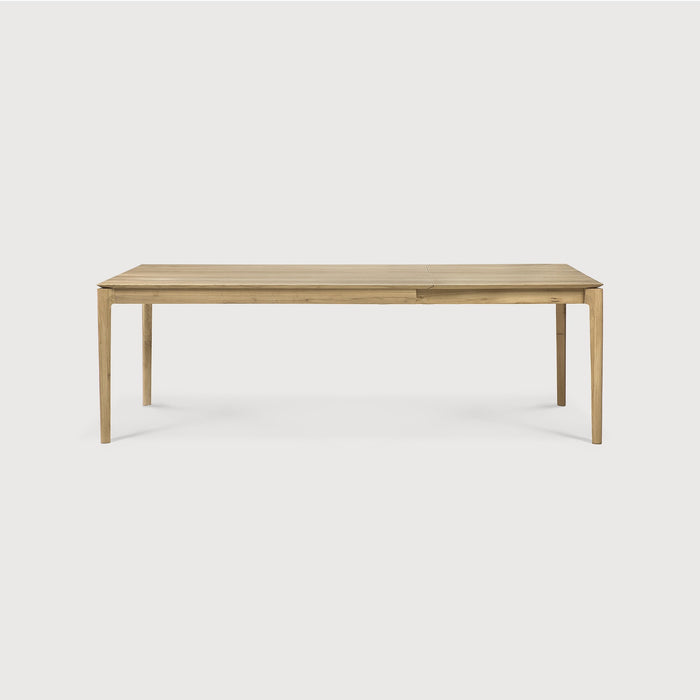 Oak Bok Extendable Dining Table side view with white background, featuring floating table top and beautiful wood joinery. - Saffron and Poe, Ethnicraft