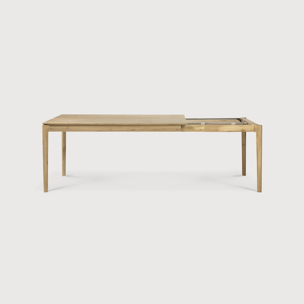 Oak Bok Extendable Dining Table side view with white background and extension mechanism, featuring floating table top and beautiful wood joinery. - Saffron and Poe, Ethnicraft