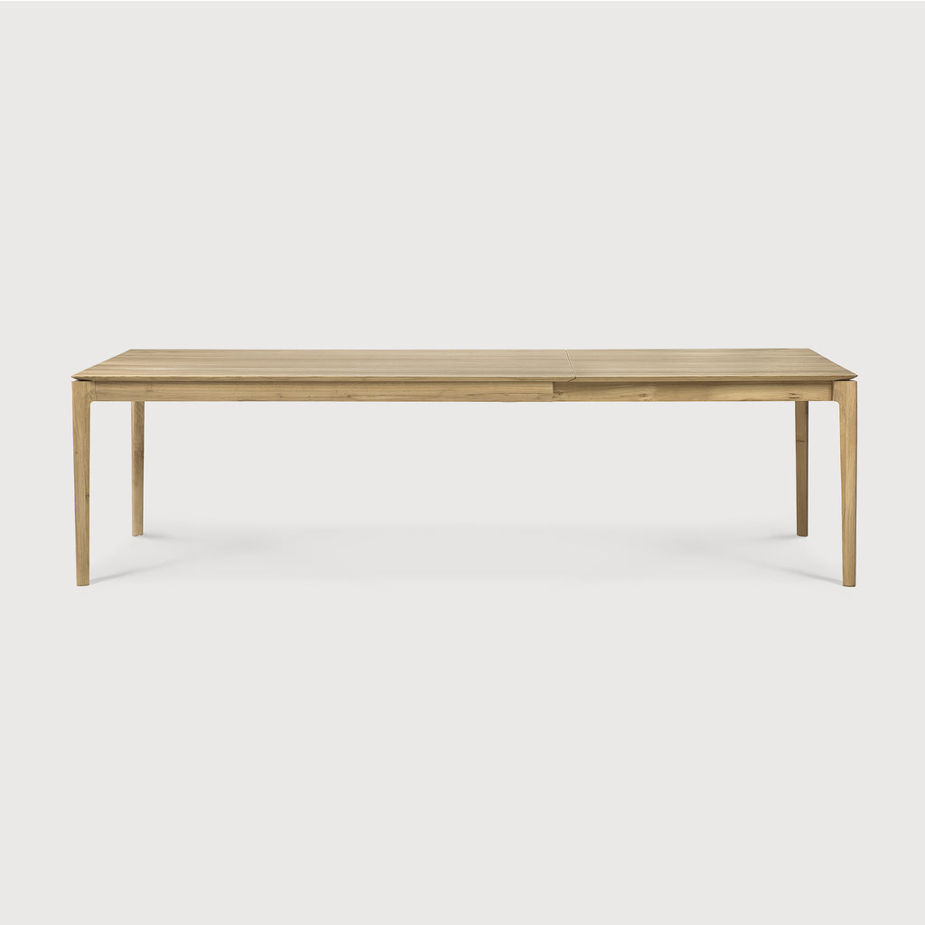 71”/110.5” long Oak Bok Extendable Dining Table side view with white background, featuring floating table top and beautiful wood joinery. - Saffron and Poe, Ethnicraft