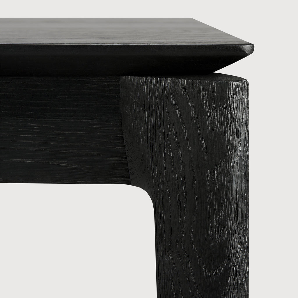 Black Oak Bok Dining Table detail with white background featuring floating table top and beautiful wood joinery. - Saffron and Poe, Ethnicraft