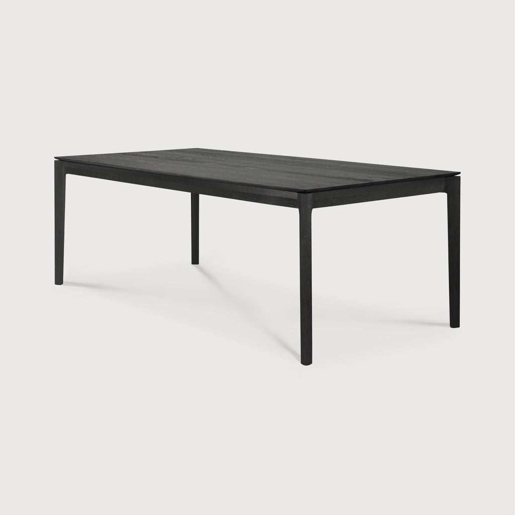Black Oak Bok Dining Table with white background at an angle, with floating table top and beautiful wood joinery. - Saffron and Poe, Ethnicraft
