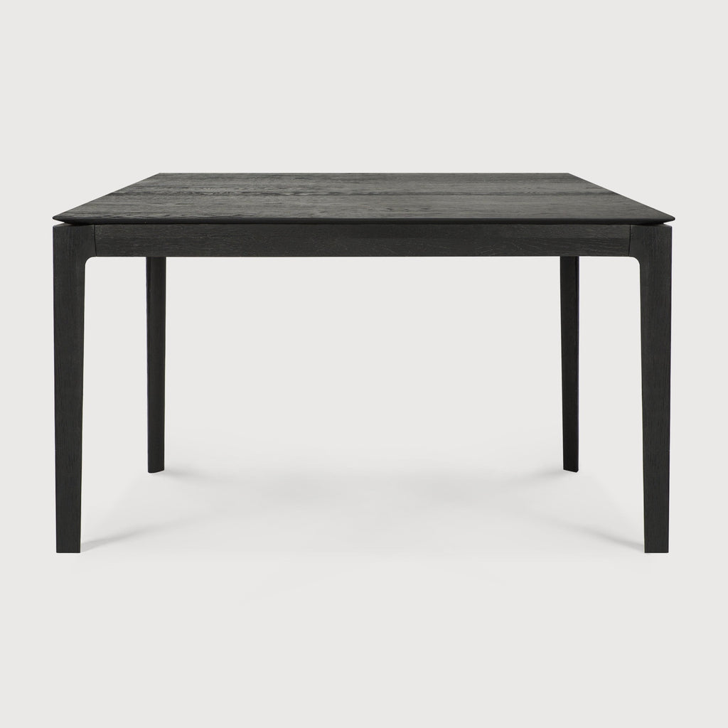 Small Black Oak Bok Dining Table side view with white background, featuring floating table top and beautiful wood joinery. - Saffron and Poe, Ethnicraft