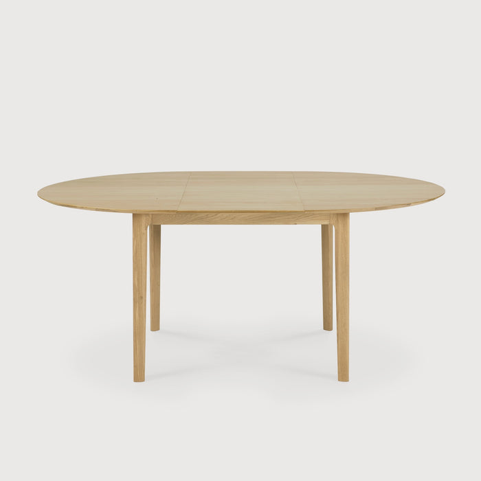Oak Bok Round Extendable Dining Table with white background side view, with floating table top and beautiful wood joinery. - Saffron and Poe, Ethnicraft