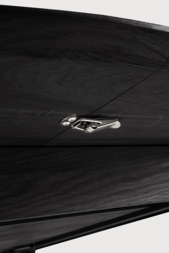 Black Oak Bok Round Extendable Dining Table close up detail of underside and extension latch mechanism with white background featuring floating table top and beautiful wood joinery. - Saffron and Poe, Ethnicraft