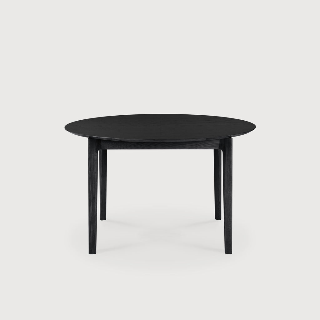 Black Oak Bok Round Extendable Dining Table side view with white background  in closed position, with floating table top and beautiful wood joinery. - Saffron and Poe, Ethnicraft