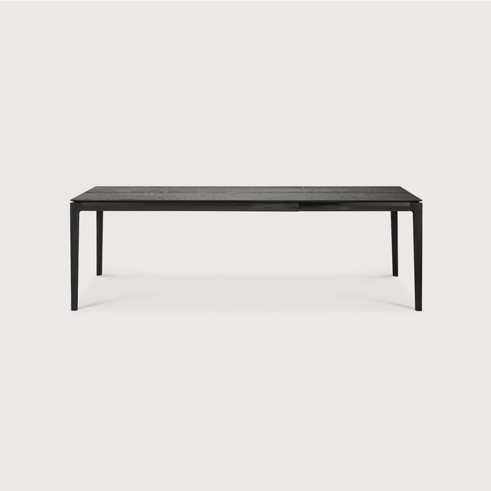 63”/94.5" long Black Oak Bok Extendable Dining Table side view with white background, featuring floating table top and beautiful wood joinery. - Saffron and Poe, Ethnicraft