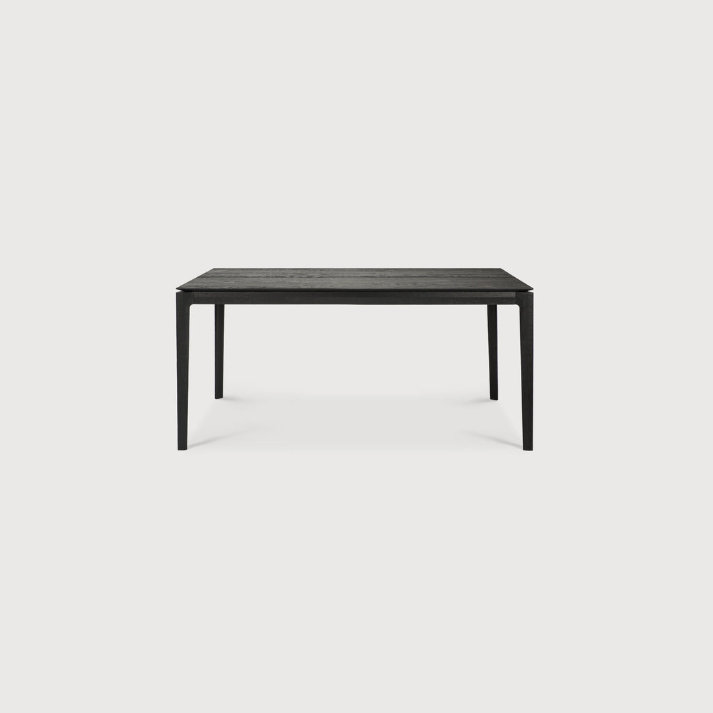 63”/94.5" long Black Oak Bok Extendable Dining Table side view in closed position with white background, featuring floating table top and beautiful wood joinery. - Saffron and Poe, Ethnicraft