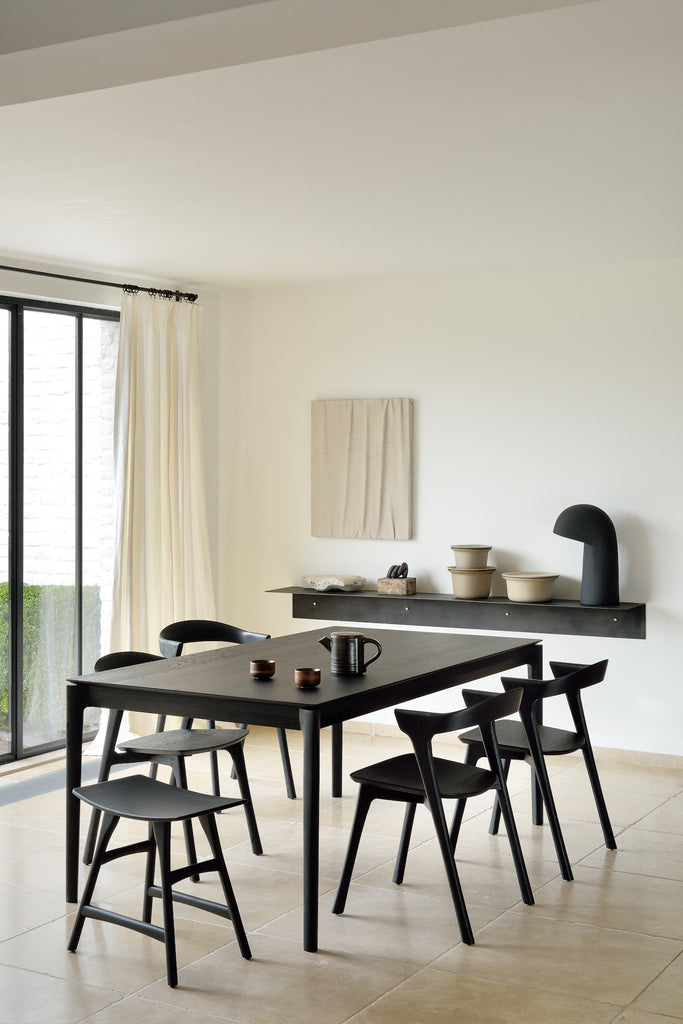 Black Oak Bok Extendable Dining Table in dining room with bok dining chairs, metal shelf with art, featuring floating table top and wood joinery. - Saffron and Poe, Ethnicraft