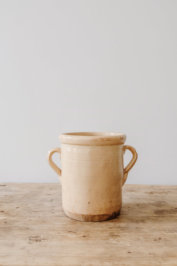 Front view of Italian Confit Pot on an Antique Coffee Table against a white wall. - Saffron and Poe
